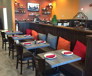 Dining area with four small tables.