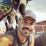 Goat Yoga man with goat on back