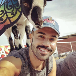 Goat Yoga man with goat on back